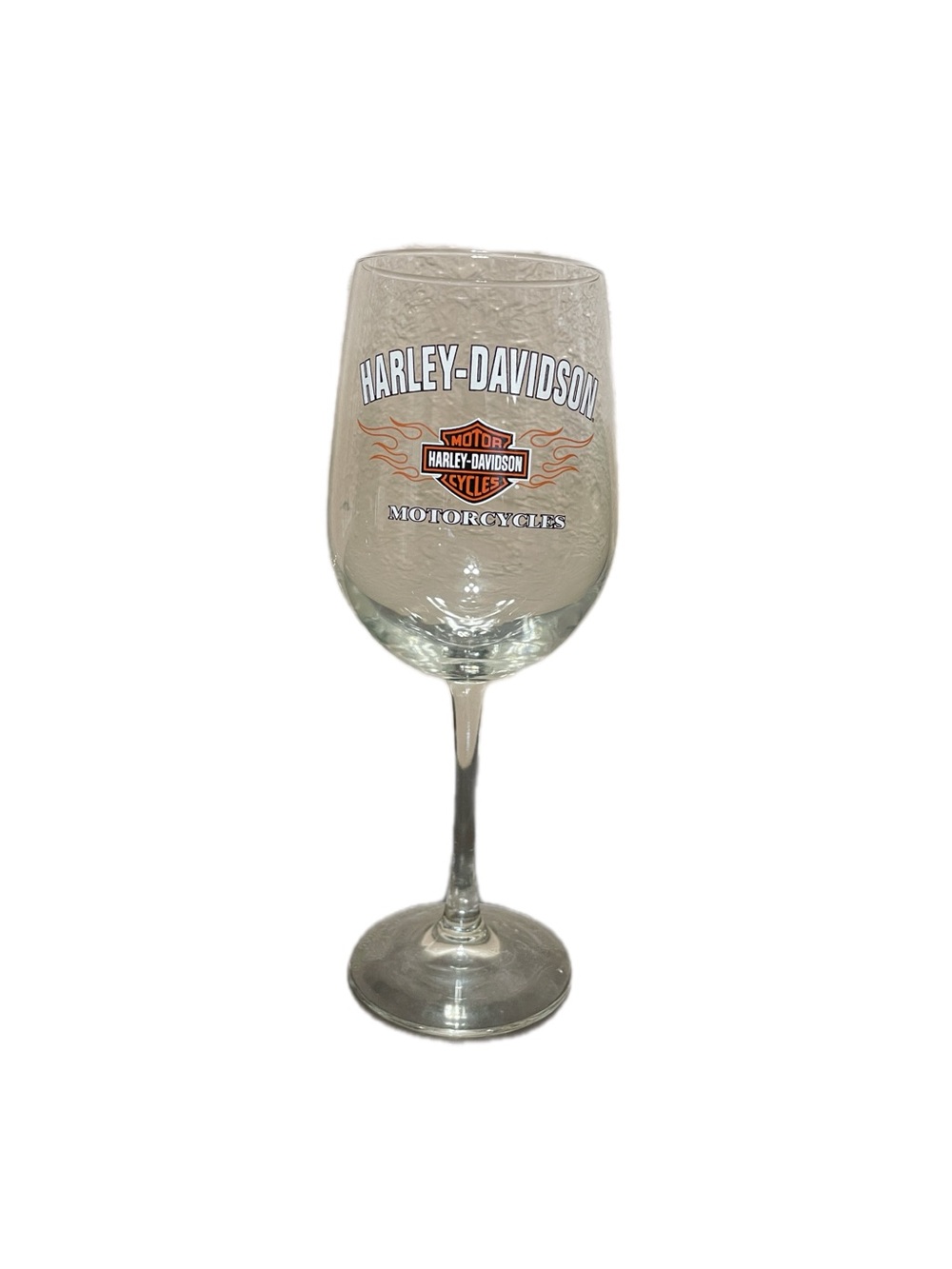 Harley-Davidson wine glass with flame and shield logo, made of clear glass.